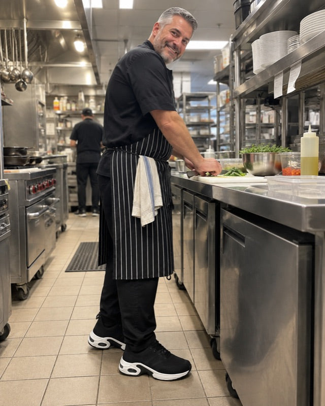 A chef working the line in the black shoes